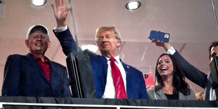 Donald Trump hands out hot dogs, schmoozes with fans at Alabama vs Georgia game