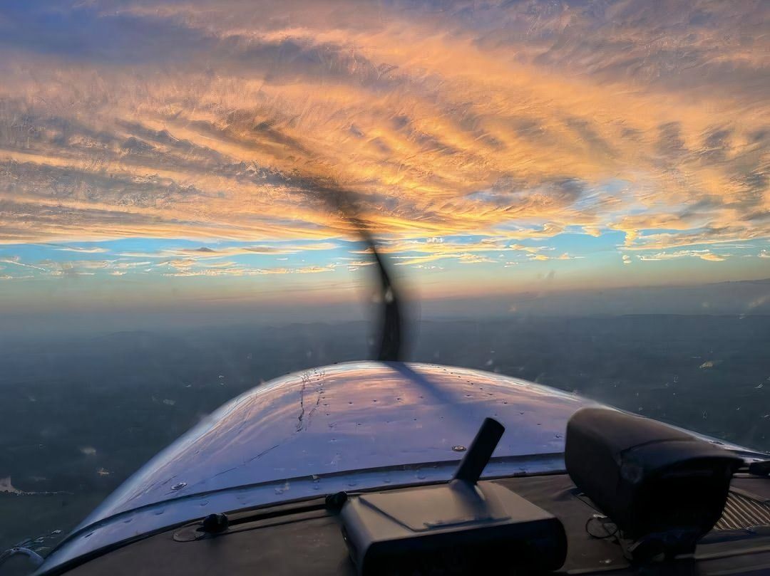 A gorgeous sunset with a Cessna cowling and propeller