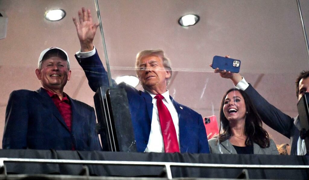 Donald Trump hands out hot dogs as he courts voters at Alabama vs Georgia game