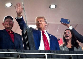 Donald Trump hands out hot dogs as he courts voters at Alabama vs Georgia game