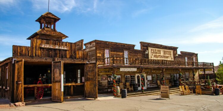 Dark brown buildings with signs that say