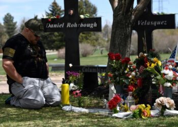 A man visits the memorial for victims of the 1999 Columbine High School shooting at the Chapel Hill Memorial Gardens in Littleton, Colorado in April 2019 (Jason Connolly)
