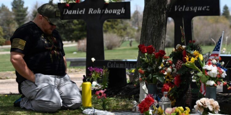A man visits the memorial for victims of the 1999 Columbine High School shooting at the Chapel Hill Memorial Gardens in Littleton, Colorado in April 2019 (Jason Connolly)
