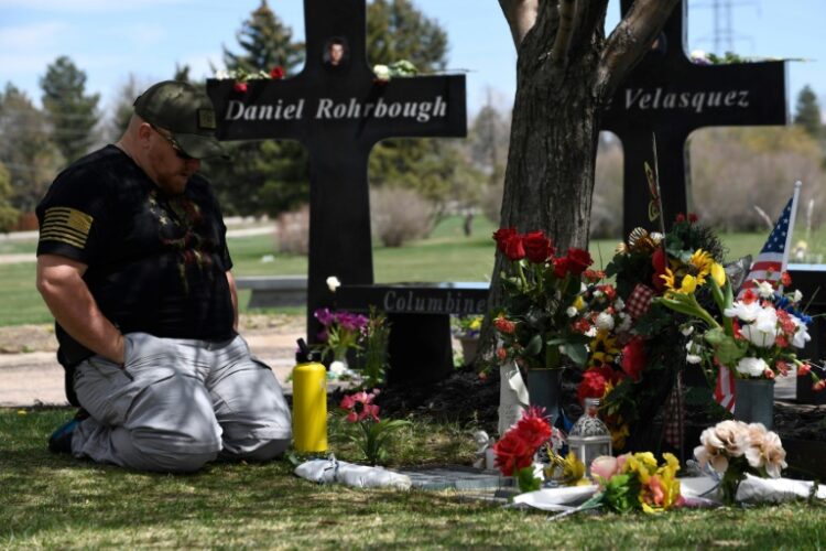 A man visits the memorial for victims of the 1999 Columbine High School shooting at the Chapel Hill Memorial Gardens in Littleton, Colorado in April 2019 (Jason Connolly)