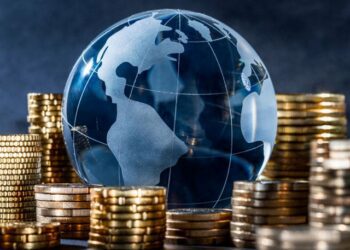 Glass globe surrounded by coins