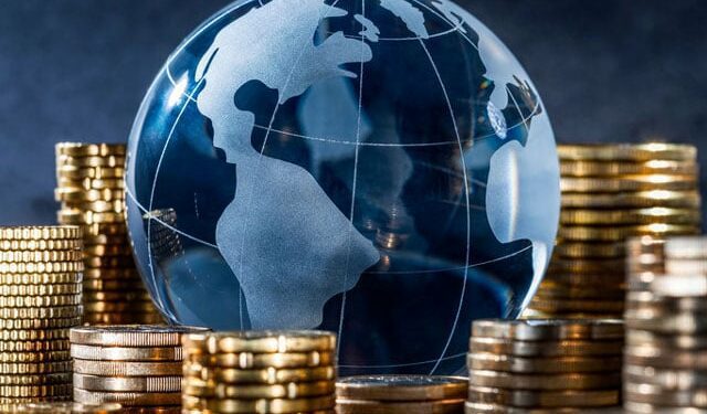 Glass globe surrounded by coins