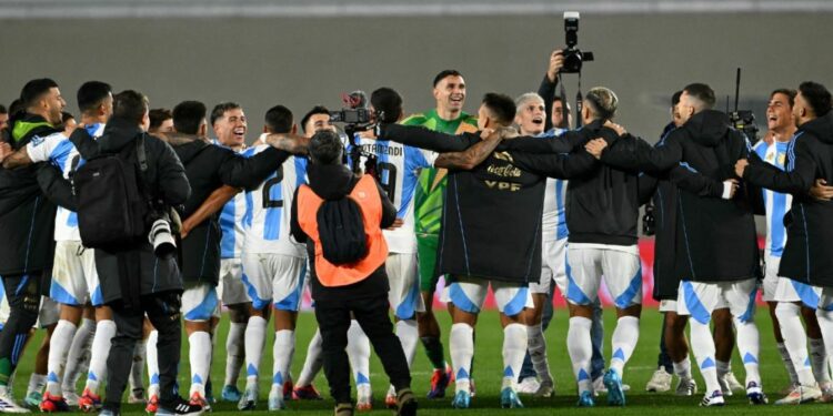 Argentina players celebrate their victory at the end of the 2026 FIFA World Cup South American qualifiers football match between Argentina and Chile at the Mas Monumental stadium in Buenos Aires on September 5, 2024.