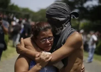 EPA A student hugs a relative after having taken shelter in the parish Divina Misericordia, in Managua, Nicaragua, 14 July 2018