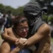 EPA A student hugs a relative after having taken shelter in the parish Divina Misericordia, in Managua, Nicaragua, 14 July 2018