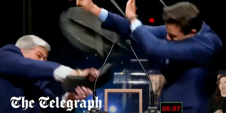 Far-Right life coach taking Brazil by storm after rival smashes chair over his head in TV debate