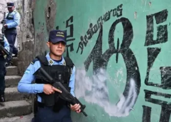 Getty Images Members of the National Police patrol in Colonia Divanna, Barrio 18 gang territory, in Tegucigalpa on March 17, 2023