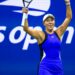 Jessica Pegula celebrates a win at the 2024 US Open, with her arms in the air, and wearing a blue dress.