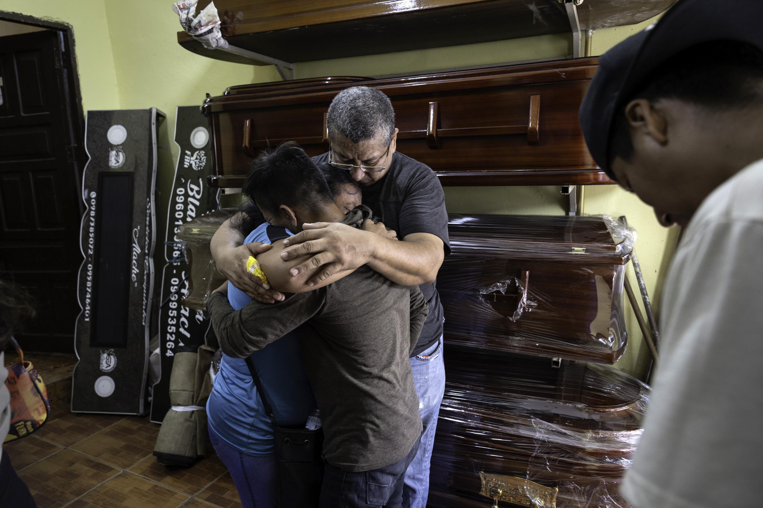 Family members mourn the death of an alleged member of the Tiguerones gang on 7 February, 2024 in Guayaquil, Ecuador. The man, 30, died while in police and military custody at the notorious Litoral Penitentiary in Guayaquil the night before, a week after he was arrested. Police released a statement saying he was found with drugs, weapons and explosives at the time of his detention.