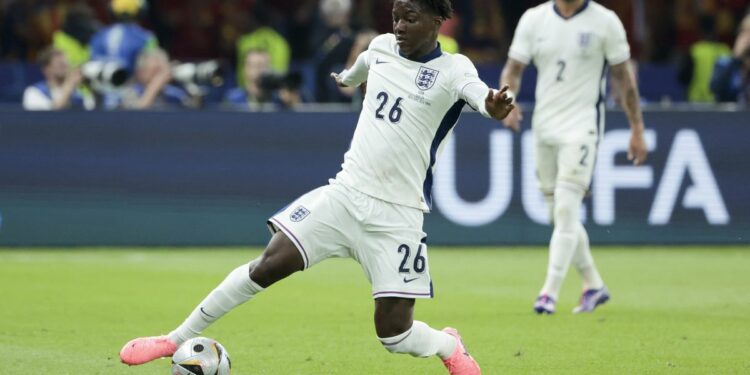 Kobbie Mainoo stretches for the ball in all white kit ahead of the Ireland vs England live stream.