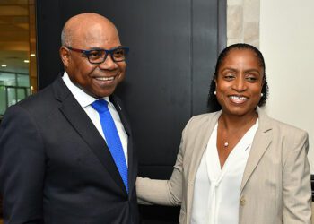 Edmund Bartlett (left), warmly greets Marie McKenzie
