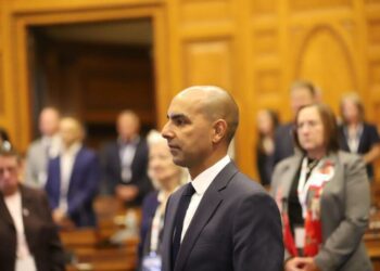 A bald man in a state Legislature chamber.