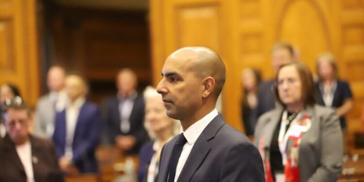A bald man in a state Legislature chamber.