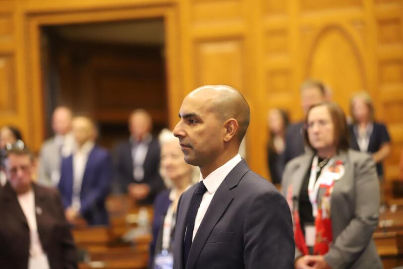 A bald man in a state Legislature chamber.