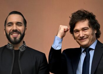Argentina's President Javier Milei gestures next to El Salvador's President Nayib Bukele on the balcony of the Casa Rosada presidential palace in Buenos Aires on September 30, 2024.