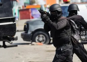 Reuters Police officers in military gear hold guns on the streets of Port-au-Prince