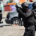 Reuters Police officers in military gear hold guns on the streets of Port-au-Prince