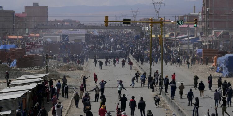 Rival protesters clash in Bolivia as ex-President Evo Morales leads a march to the capital