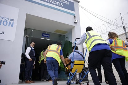 A former prisoner receives assistance in getting to the terminal by La Aurora airport workers in Guatemala City.