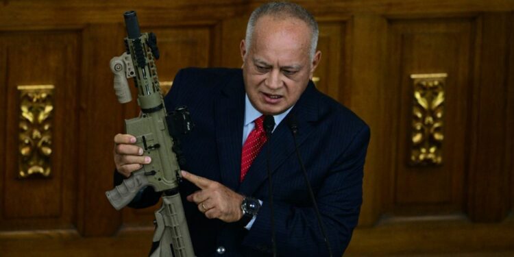 Venezuela's Interior Minister Diosdado Cabello holds a US made M4A1 rifle as he speaks during a session at the National Assembly in Caracas on September 17, 2024.