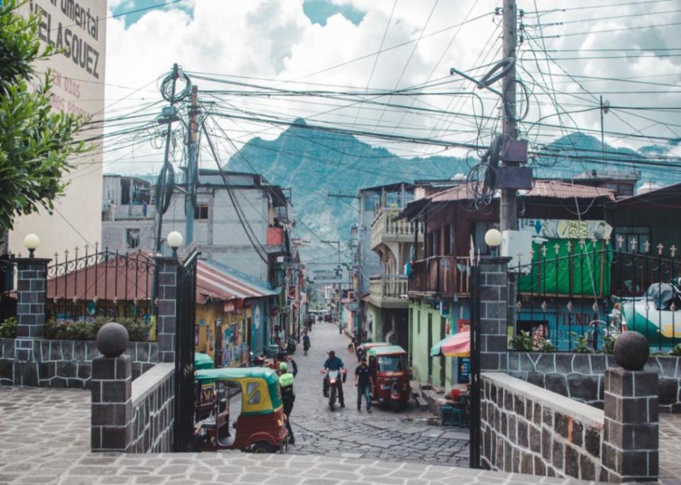 Daily scene of tuktuks, street stalls and motorbikes in San Pedro