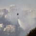 A helicopter sprays water over a bushfire on a hill in Quito on September 25, 2024 (Galo Paguay)