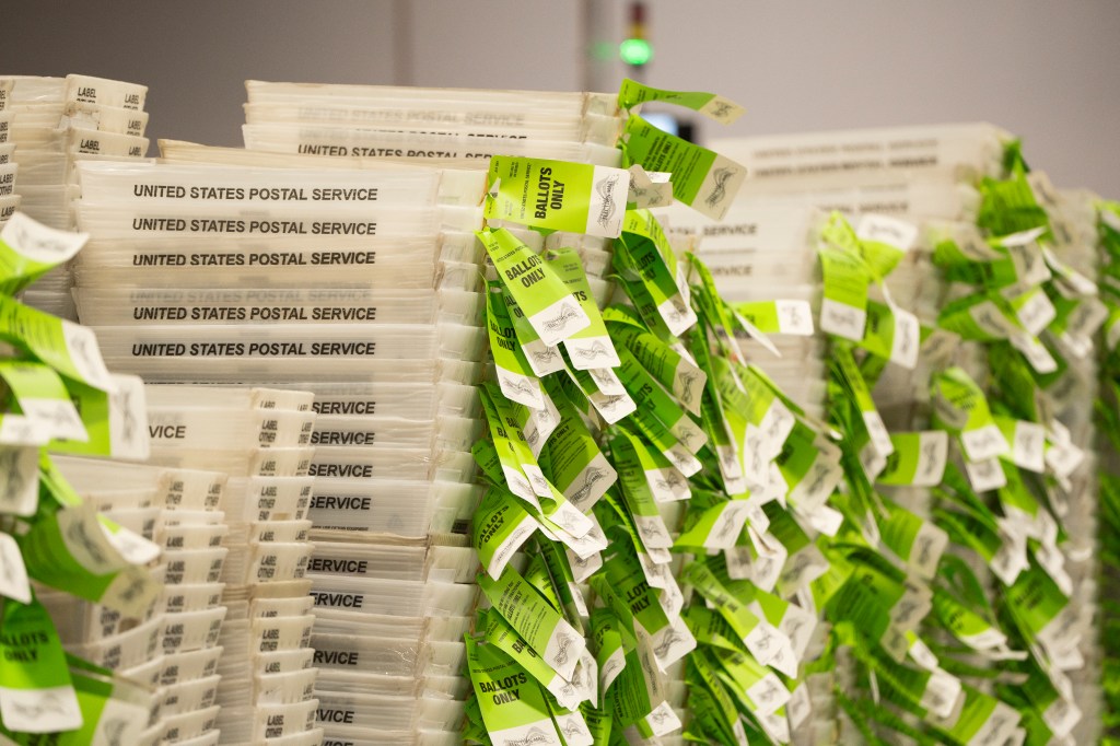 United States Postal Service containers marked 'BALLOTS ONLY' at Runbeck Election Services in Phoenix, Arizona, where mail-in ballots are printed for 30 states.