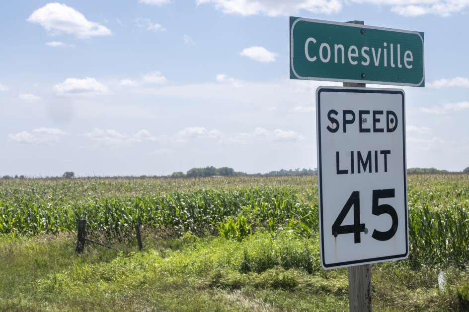 The sign entering Conesville, Iowa, in July 2022, where T. Bell Detasseling employs hundreds of H-2A workers. (Sky Chadde/Investigate Midwest)