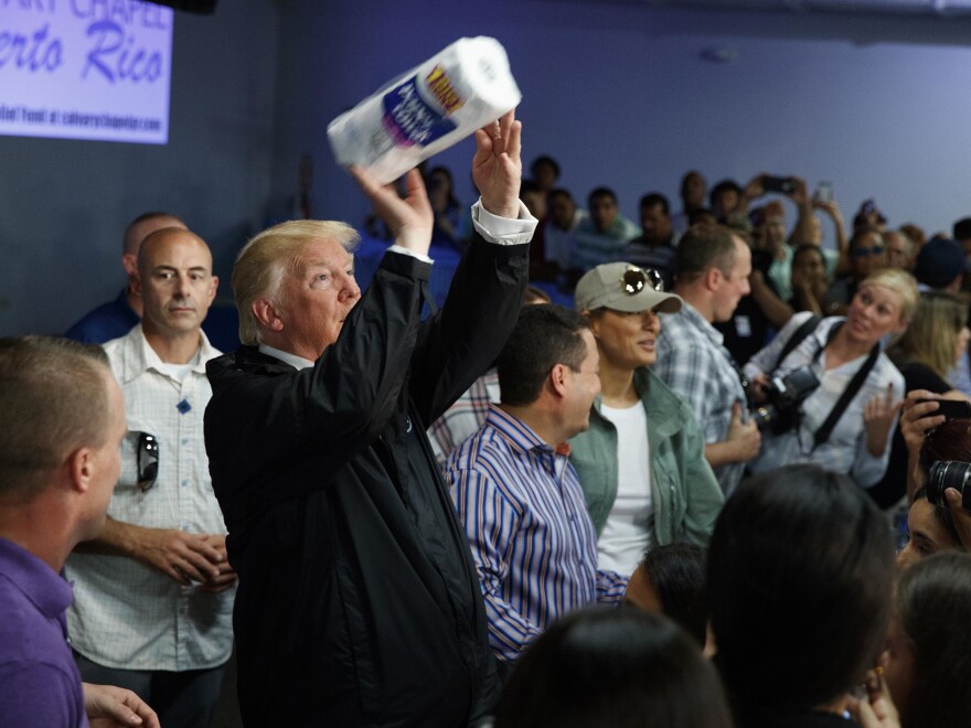 President Trump tosses paper towels into a crowd at Calvary Chapel in Guaynabo, Puerto Rico, during a post-Maria visit in October 2017.