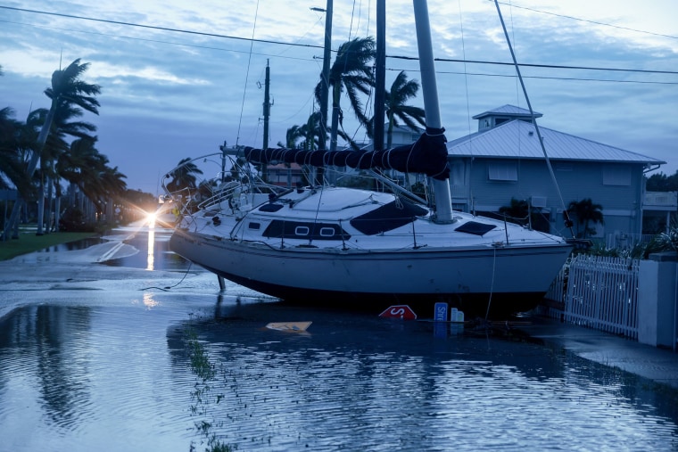 A boat rests in a yard on Oct. 10, 2024, after it was washed ashore by Hurricane Milton in Punta Gorda, Fla.