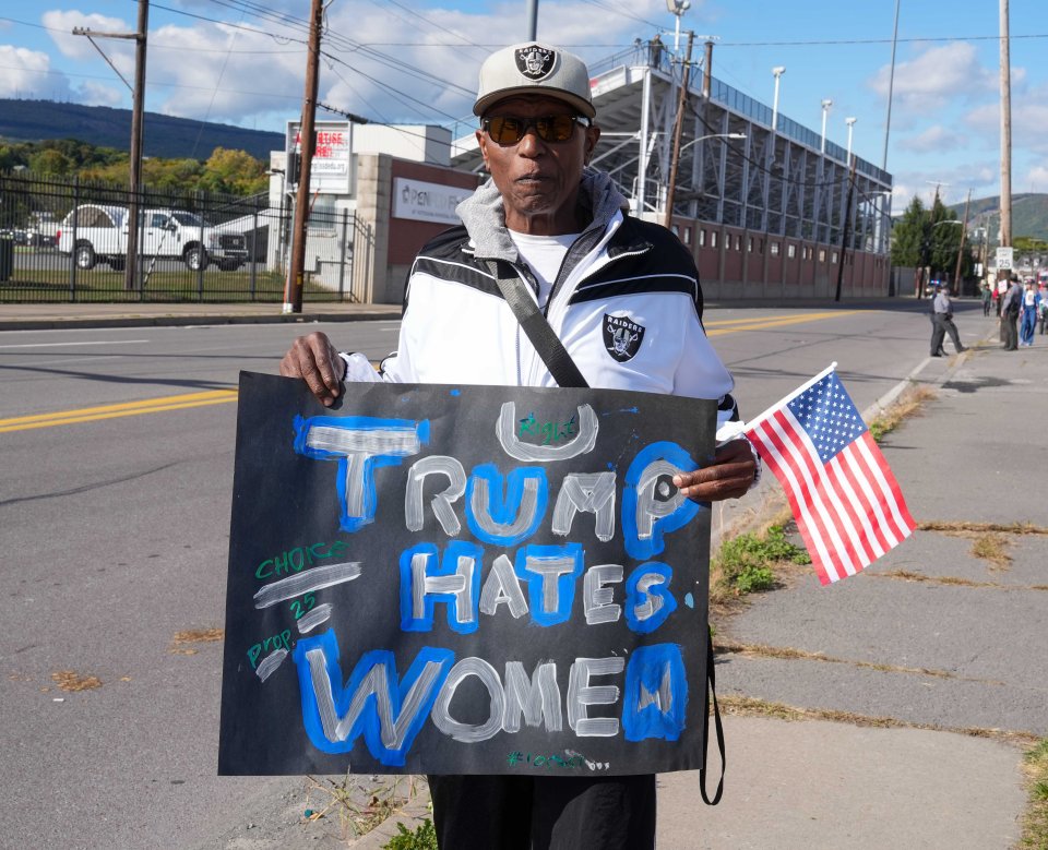 Outside the rally, protestor Mark Scott, 63, held aloft a sign reading: 'Trump hates women'