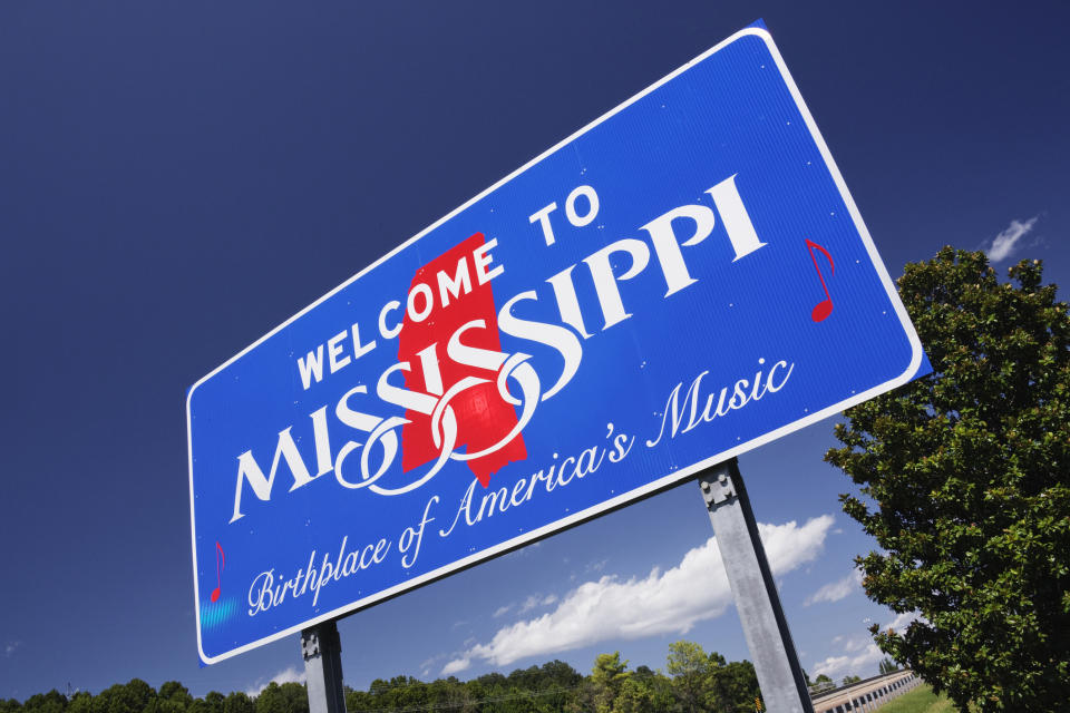 Welcome sign for Mississippi, highlighting it as the birthplace of America's music, against a clear sky