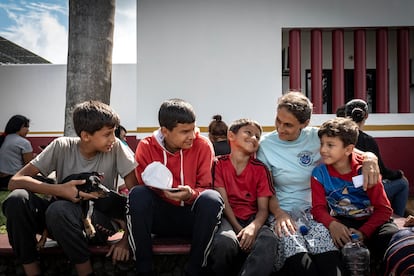 Yolimar, from Venezuela, rests with her children and her dog outside the Siglo XXI Immigration Station in Tapachula.