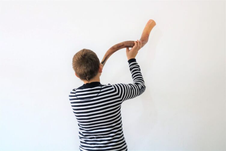 A boy blowing a shofar