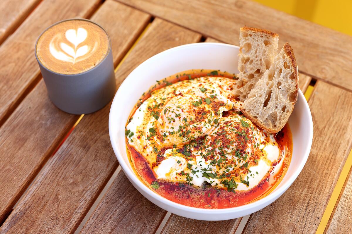 A photo of Turkish eggs paired with a latte at Lokl Haus in Santa Monica.