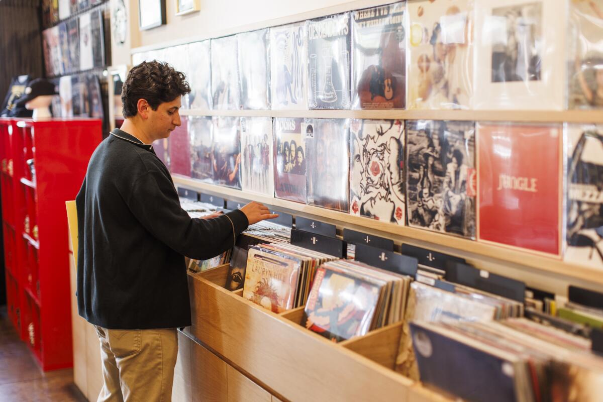 Justin Levine looks through the stacks of records at the Licorice Pizza store in L.A. on Oct. 4.