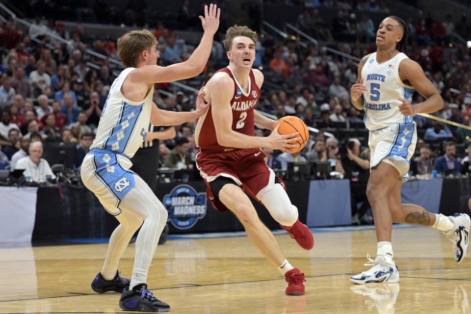 Mar 28, 2024; Los Angeles, CA, USA; Alabama Crimson Tide forward Grant Nelson (2) controls the ball against North Carolina Tar Heels guard Paxson Wojcik (8) in the semifinals of the West Regional of the 2024 NCAA Tournament at Crypto.com Arena. Mandatory Credit: Jayne Kamin-Oncea-USA TODAY Sports