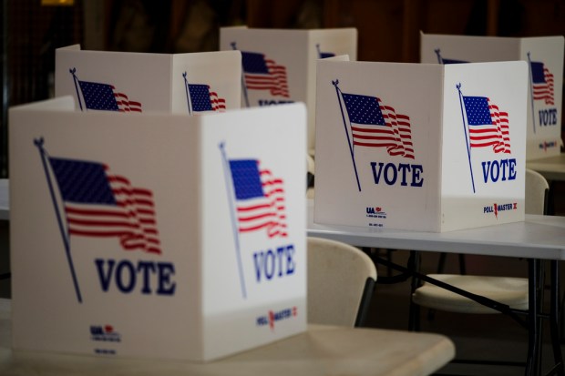 FILE – Voting booths are set up at a polling...