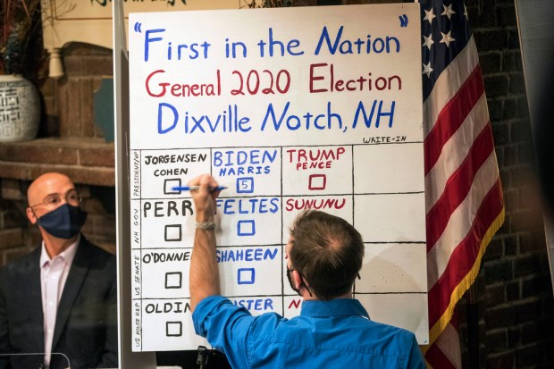 FILE – A man tallies the votes from the five...