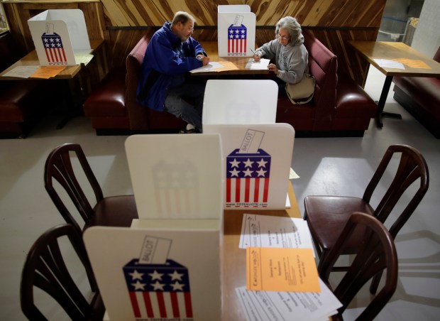 FILE – John and Colleen Kramer, of Stockton, Mo., vote...