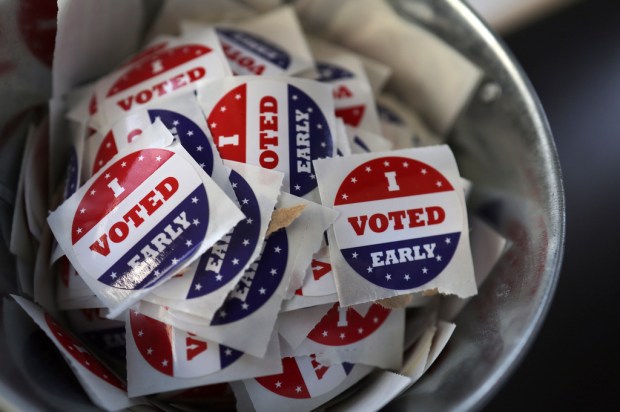 FILE “- I Voted Early” stickers sit in a bucket...