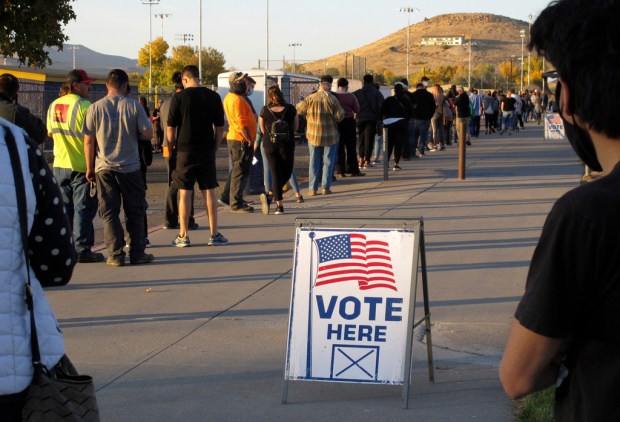 FILE – People wait to vote in-person at Reed High...