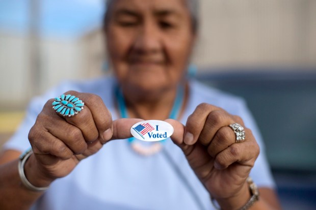 FILE – Mildred James of Sanders, Ariz., shows off her...