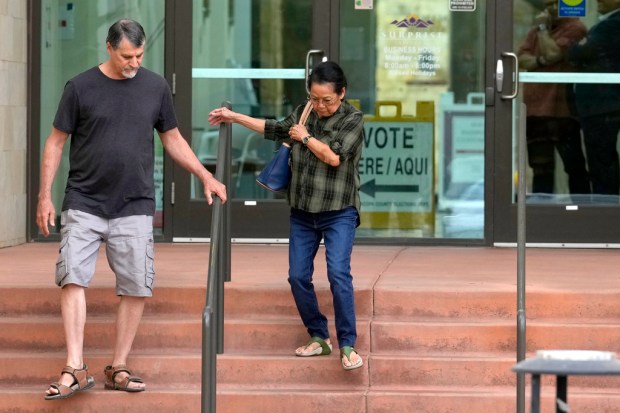 Voters leave Surprise City Hall after voting on the first...