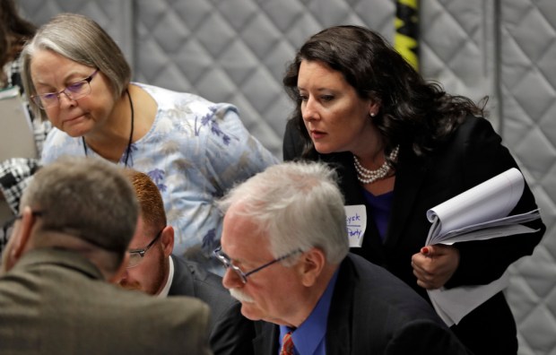 FILE – Democratic party observer Rachel May Zysk, right, looks...