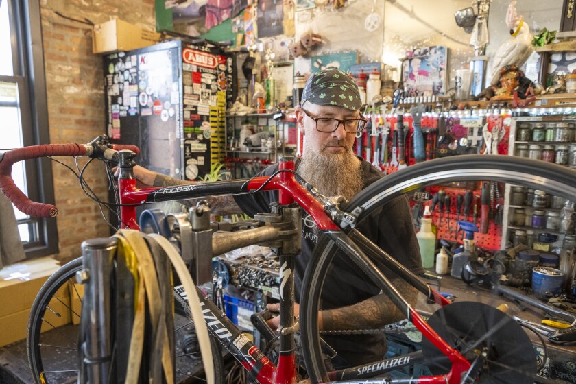 Aaron Brown who’s been working 20 years at Working Bikes, works on a bike at workshop at Working Bikes located in Little Village, Wednesday, Oct. 9, 2024.